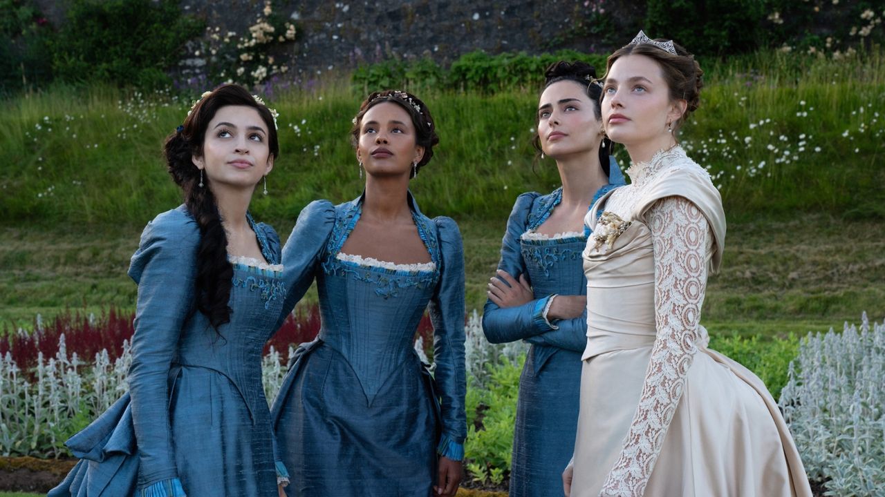 Josie Totah, Alisha Boe, Aubri Ibrag and Kristine Frøset wearing gilded age dresses in a garden in a still from the buccaneers season 2