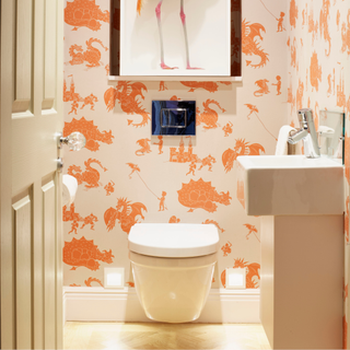 Toilet / cloakroom, orange and white dragon designer wallpaper by PaperBoy, floating basin, taxidermy bird ( flamingo )