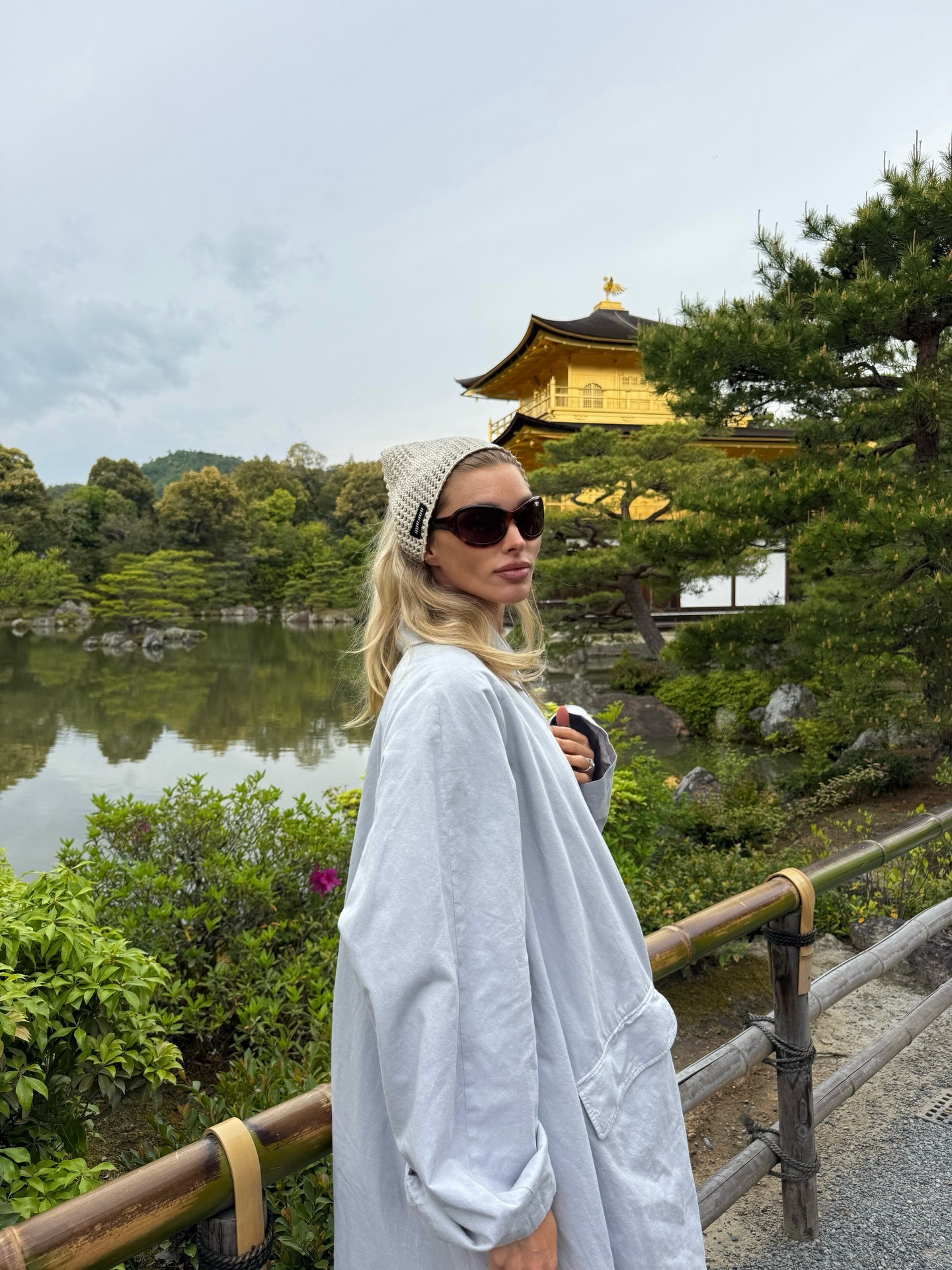 Elsa Hosk in Japan wearing a crochet head scarf and bug-eye sunglasses.