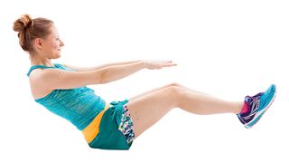 Woman wearing workout clothing doing a V tuck exercise move
