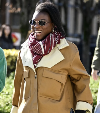 Nikki Ogunnaike wearing a scarf, a coat, and sunglasses 