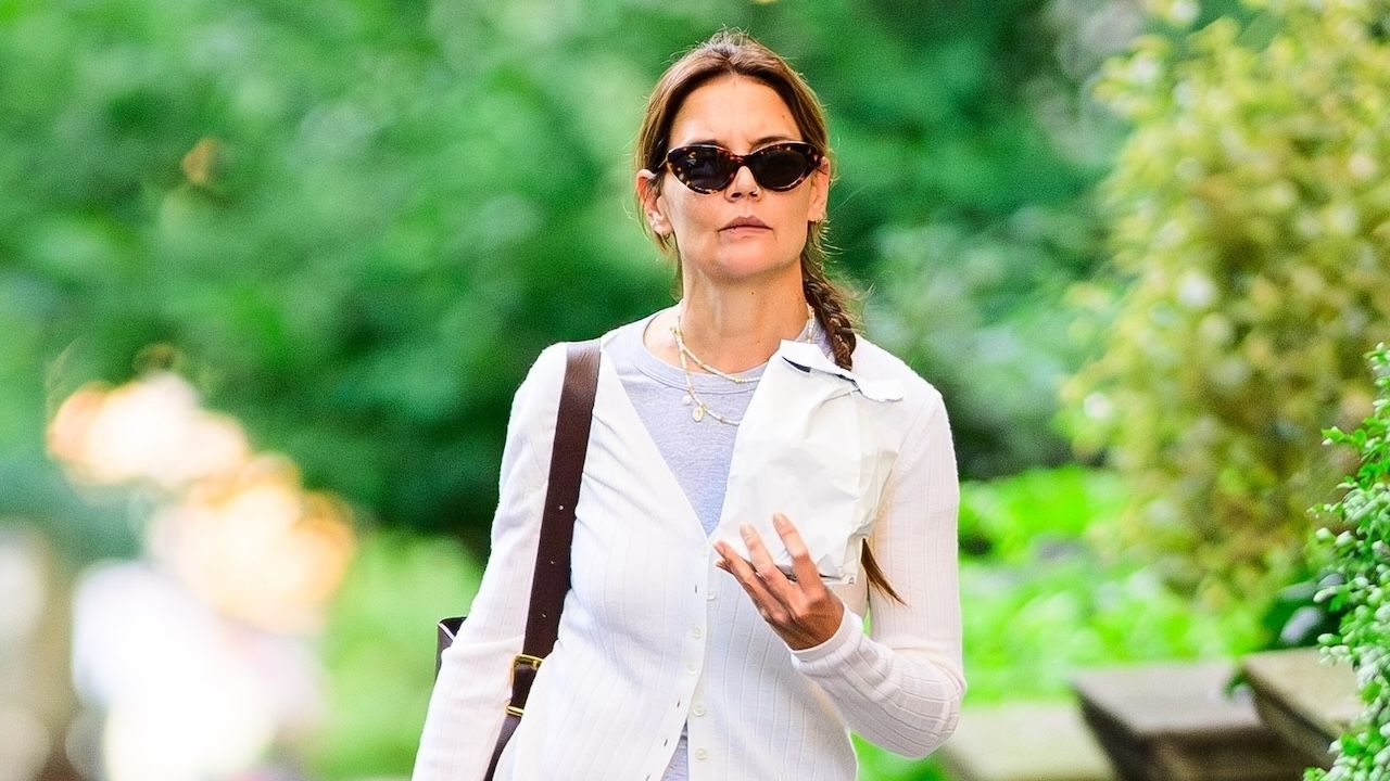 Katie Holmes wearing a white jacket, gray shirt, and wide leg jeans in New York City August 2024