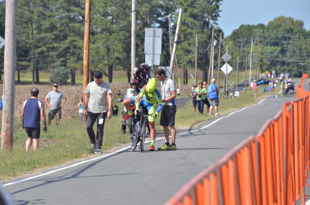 Michael Valgren throwing his leg over the saddle