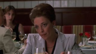 Rosaline Aprile in The Sopranos, eating at a table in a restaurant.