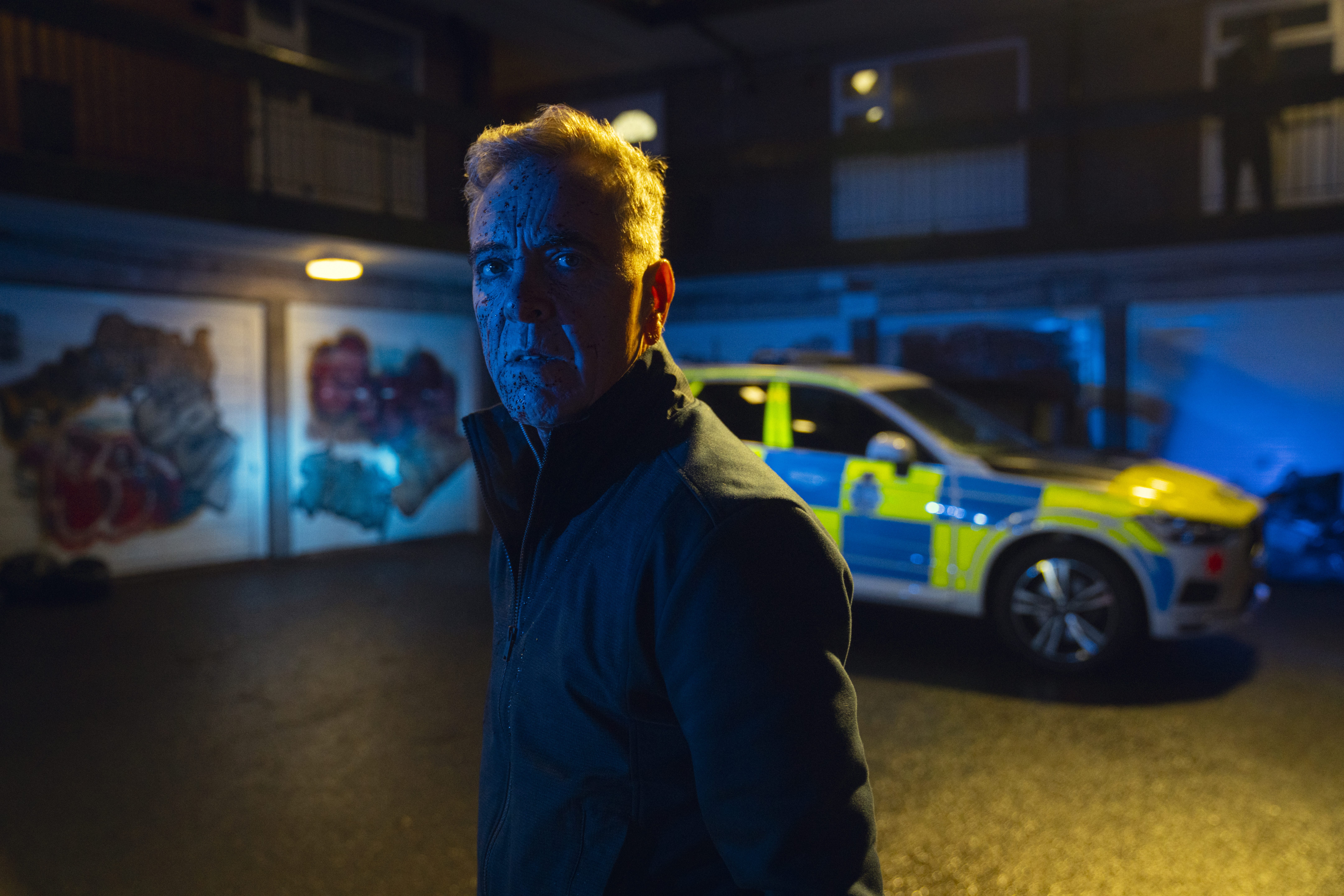 james nesbitt as simon greene walking in a dimly lit garage while investigating his daughter's disappearance in the harlan coben mystery run away