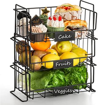Three stacked wire baskets with fruit and other food inside