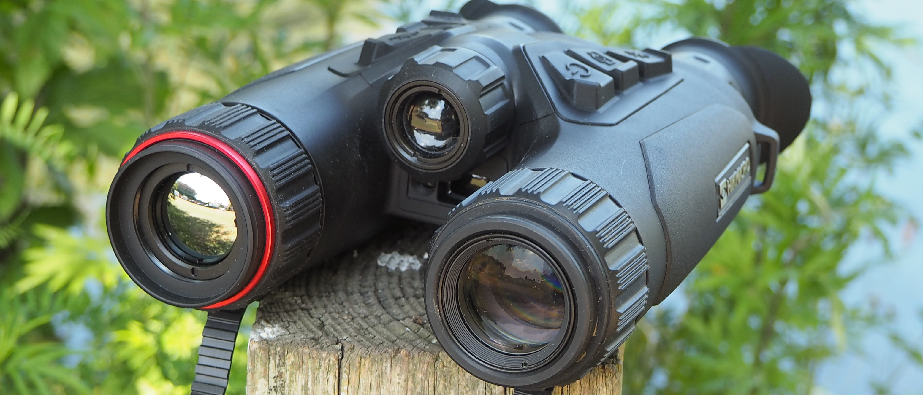HikMicro Habrok 4K HE25L binoculars sitting on a post