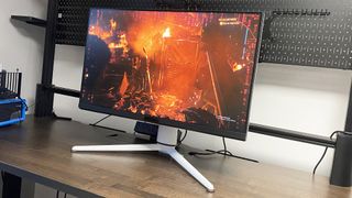 A photo of a BenQ MOBIUZ EX321UX gaming monitor on a desk