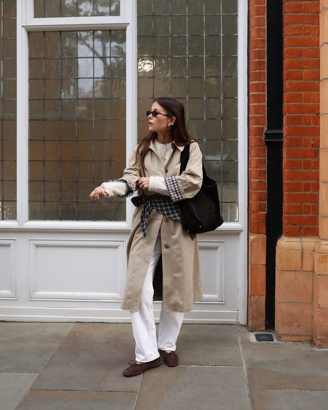 Alice in white cardigan and jeans and a trench with brown suede ballet flats