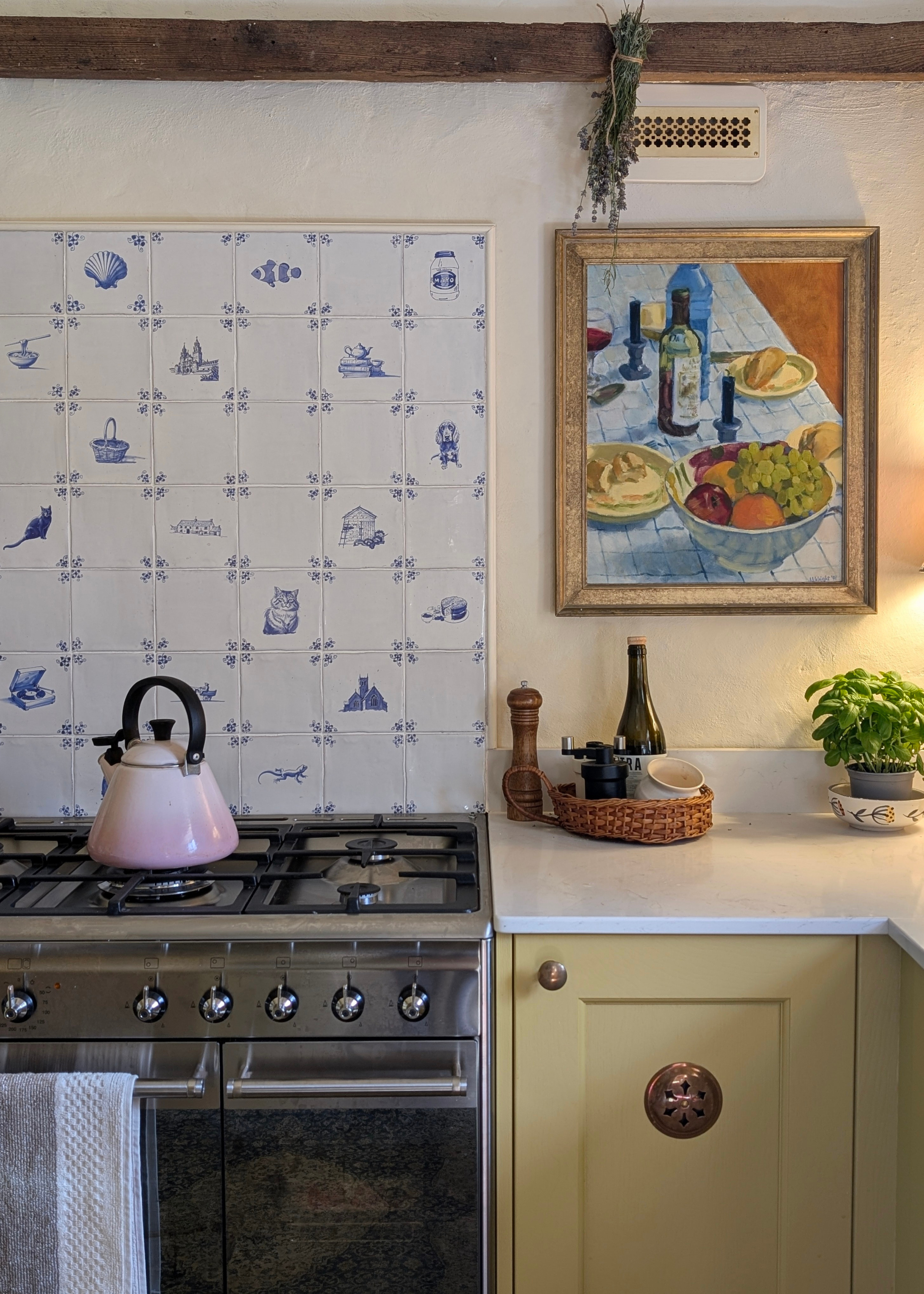 traditional country kitchen with yellow cabinets and a custom delft tile backsplash