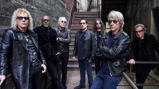 Bon Jovi posing in an alleyway