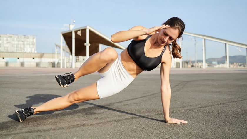 a photo of a woman doing a side crunch