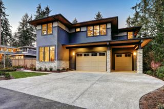 A modern home with a large driveway and a double garage
