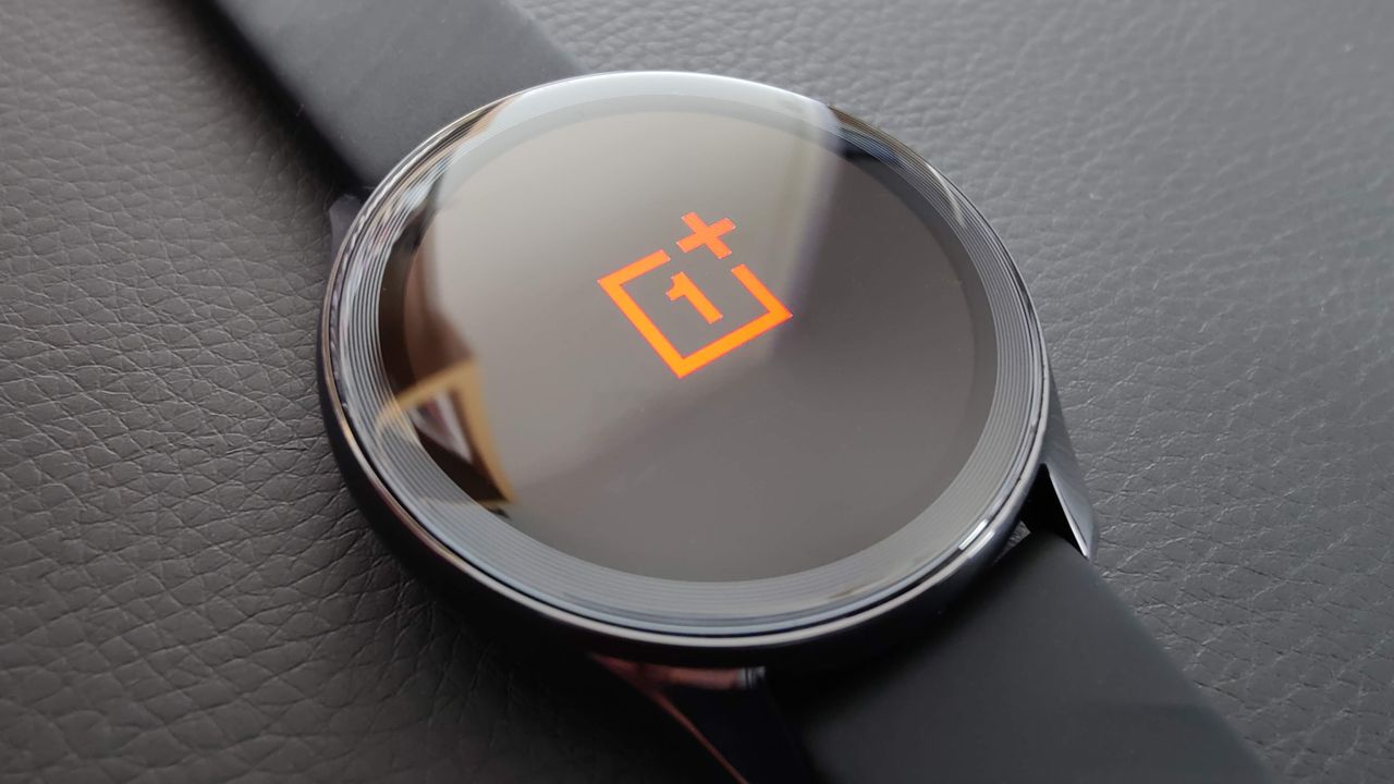 OnePlus Watch shown on black leather surface