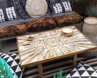 A hand-painted pallet coffee table with white paint decor