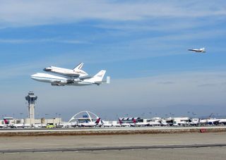 NASA's space shuttle Endeavour flies over Los Angeles International Airport while riding piggyback atop its Shuttle Carrier Aircraft on Sept. 21, 2012, during a4.5-hour aerial tour over California. The shuttle was being delivered to L.A.