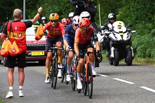 PAU FRANCE JULY 12 LR Magnus Cort of Denmark and Team UnoX Mobility Romain Gregoire of France and Team Groupama FDJ and Michal Kwiatkowski of Poland and Team INEOS Grenadiers compete at the feed zone during the 111th Tour de France 2024 Stage 13 a 1653km stage from Agen to Pau UCIWT on July 12 2024 in Pau France Photo by Tim de WaeleGetty Images