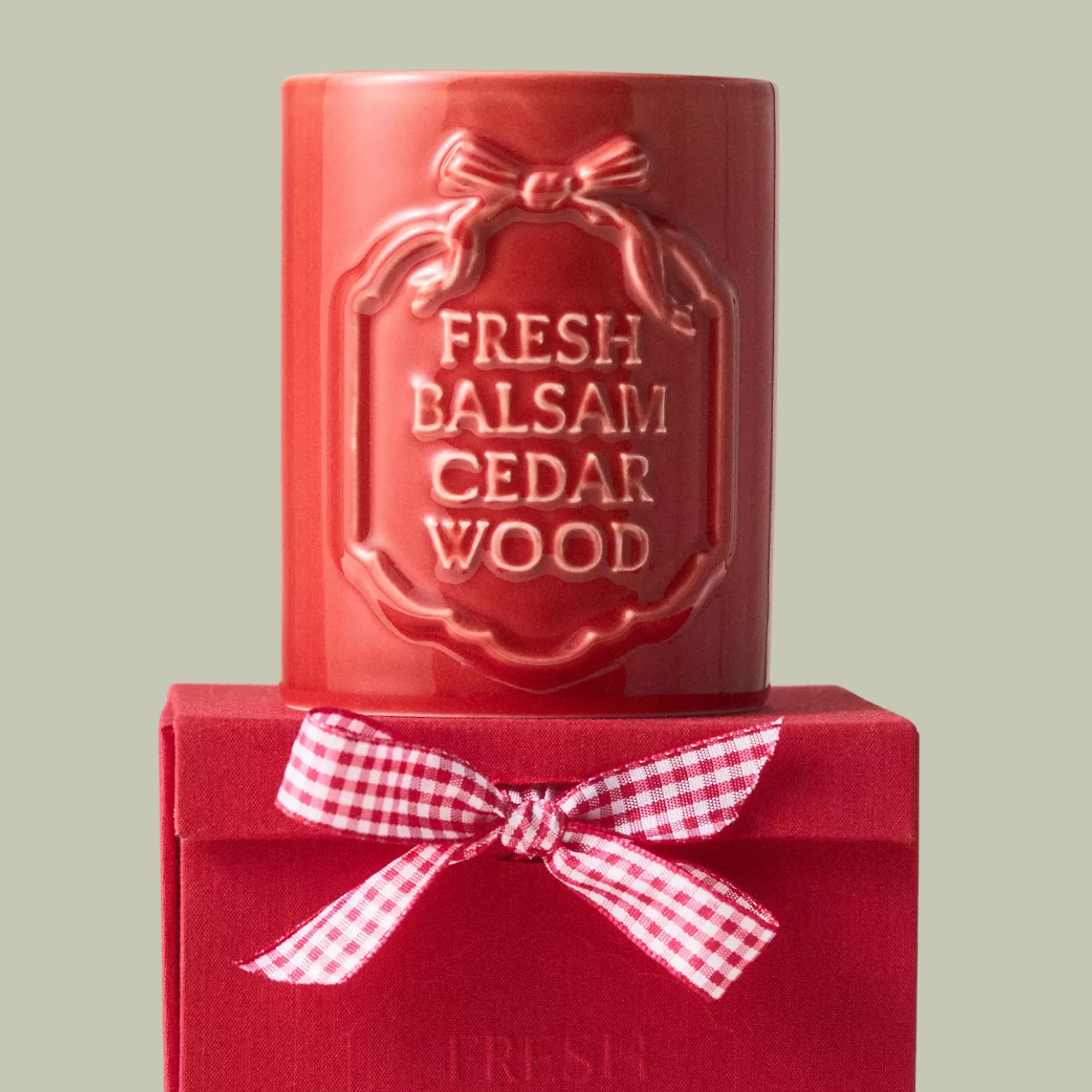A red ceramic scented candle