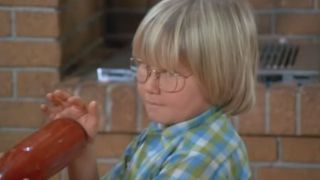 Cousin Oliver holding a ketchup bottle in The Brady Bunch