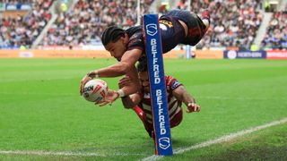Lewis Murphy of St.Helens scores his team's first try during the Betfred Super League match between Wigan Warriors and St Helens at Brick Community Stadium on April 18, 2025 in Wigan, England.