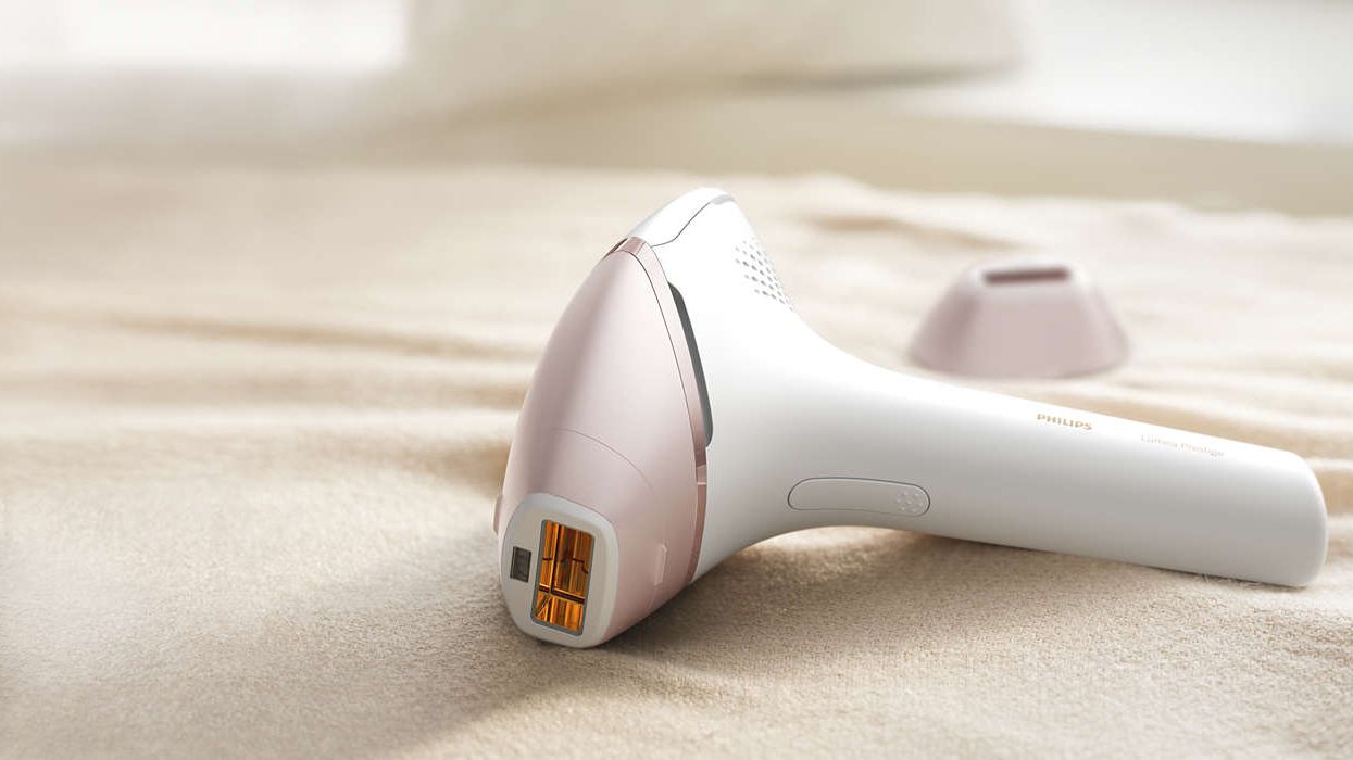 Philips Lumea Prestige IPL on a bed