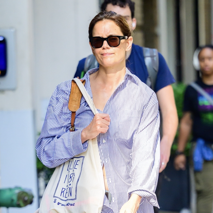 Katie Holmes is pictured while out running errands this morning, wearing a striped dress shirt, baggy denim, and black flats. Sept. 19