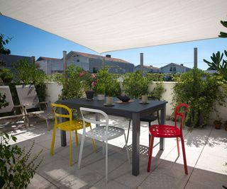 balcony garden covered with a large white sail shade to create privacy and shade