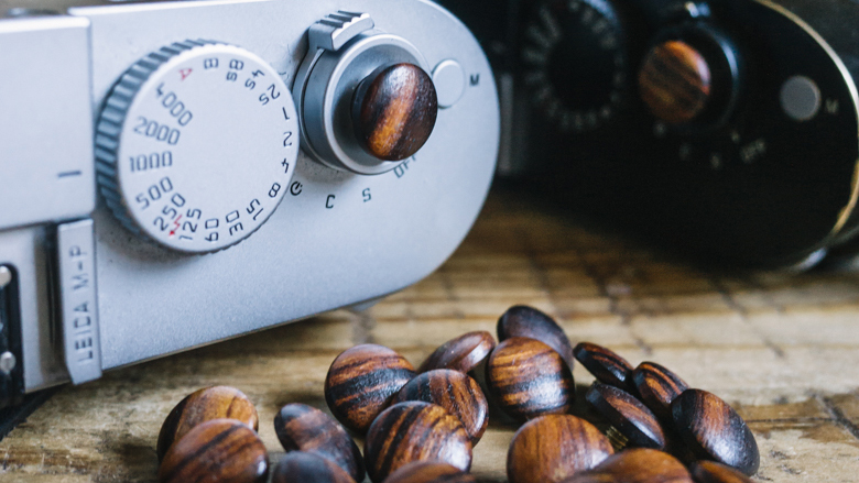 Teak camera shutter buttons next to a camera