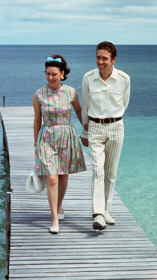 Princess Margaret, the younger sister of Britain's Queen Elizabeth II, walks 14 March 1967 with her husband Earl of Snowdon on a pontoon in the Bahamas