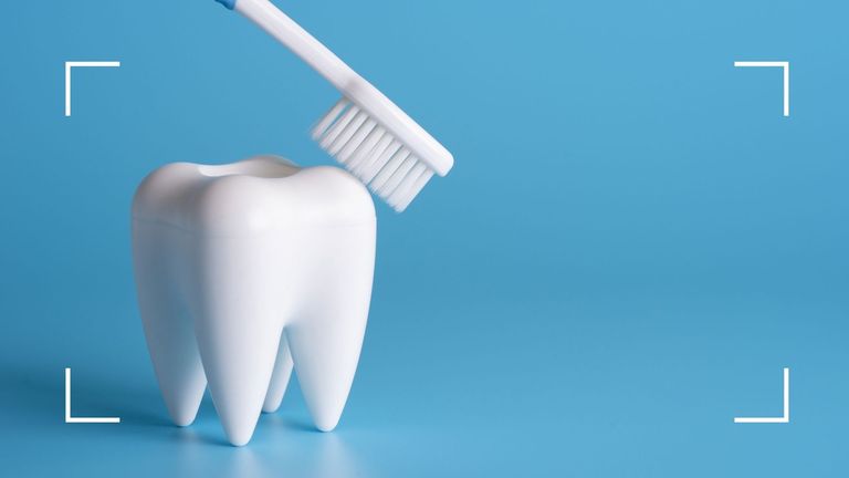 toothbrush and white tooth on blue background