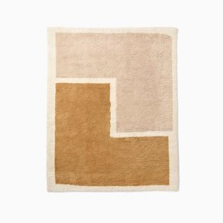 Flatlay of color-blocked shaggy rug in neutral tones
