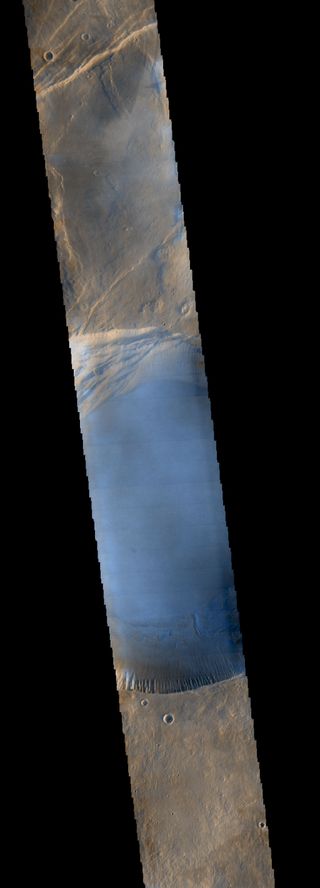 This image from NASA's Mars Odyssey orbiter shows clouds around the summit of Pavonis Mons, a giant volcano on Mars.