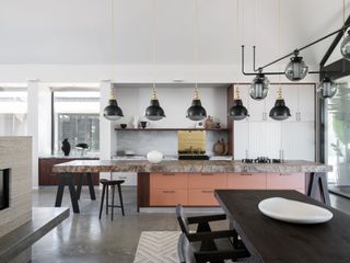 a modern kitchen with a long red island