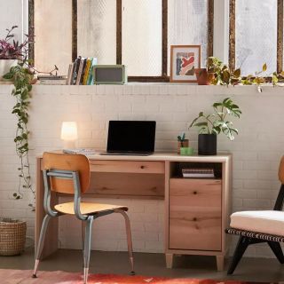 an industrial desk and work area situated near windows