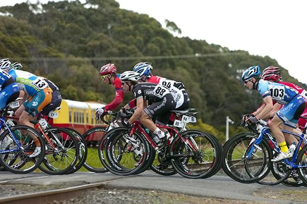 Riders cross a railway line in Devonport during another undulating stage of the tour.