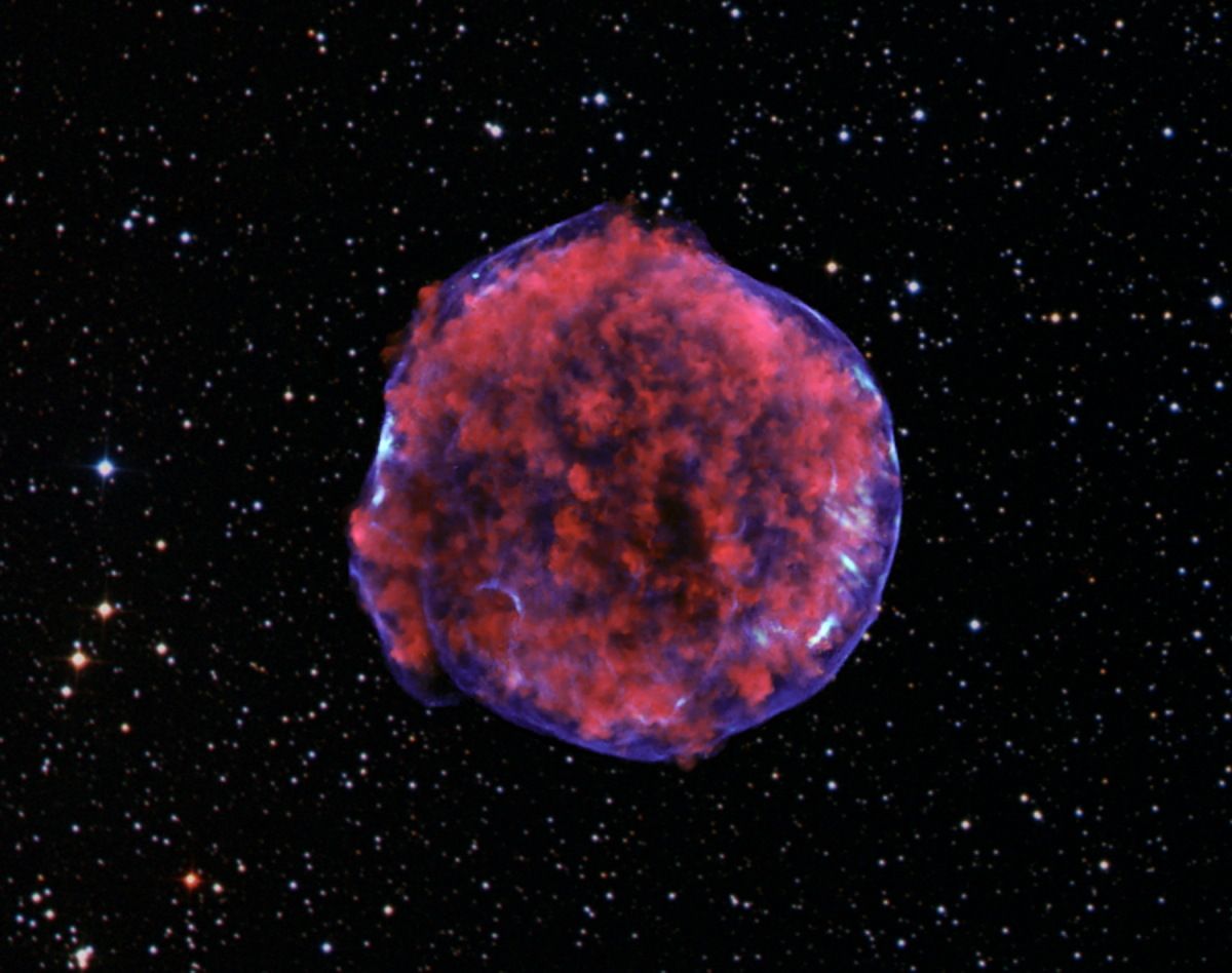 The Tycho Type IA supernova remnant, as imaged by NASA&#039;s Chandra X-ray Observatory. Low-energy X-rays (red) in the image show expanding debris from the supernova explosion and high energy X-rays (blue) show the blast wave, a shell of extremely energetic electrons. 