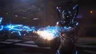 Still from the movie Blue Beetle (2023). Blue Beetle shooting energy pulse from hands.