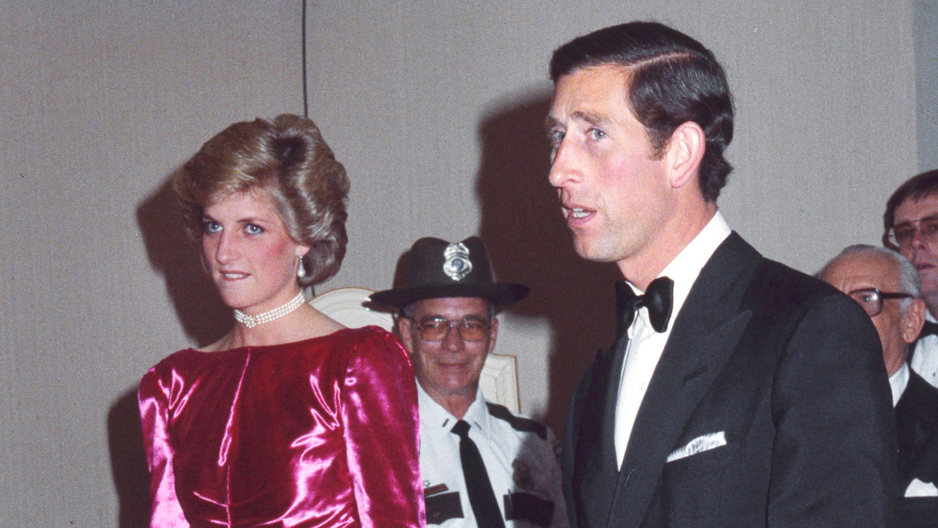 Princess Diana wears a cerise pink dress and diamonds, and King Charles wears a tuxedo