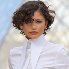 Zendaya attended the Louis Vuitton Fall 2026 fashion show in a white bubble-hem skirt set