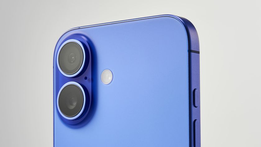 Close-up of a blue iPhone 16 smartphone showing dual camera lenses and a small sensor, against a light gradient background