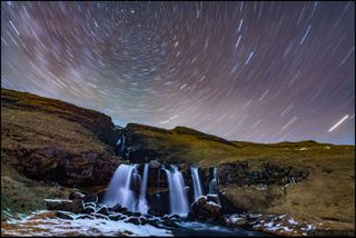 Astrophotographer Babak Tafreshi took this image on a clear March night in Iceland. "This single exposure of 20 minutes was enough to show our constantly rotating planet," he wrote in an image description on his website. "The camera on a fixed tripod records this as star trails around the north celestial pole (top), marked by the North Star or Polaris. This is the direction of the Earth rotation axis. On Earth, is one of the 10,000 waterfalls listed in Iceland."