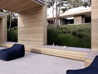 The structure of the pool house also serves as built-in seating when the family is entertaining