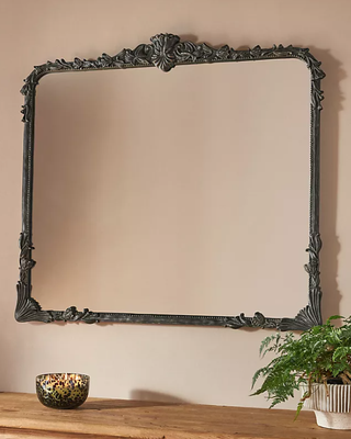Wall mirror with antique black frame.