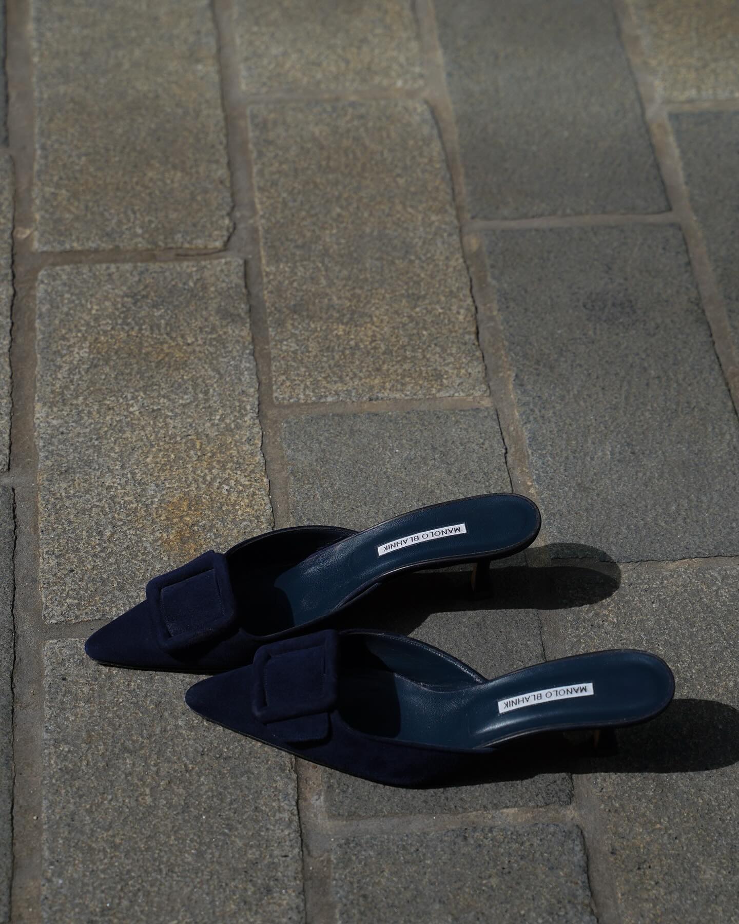 An image of @amagodson_a showcasing a navy colour of Manolo Blahnik Maysale mules