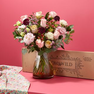 flower in vase with box and pink wall