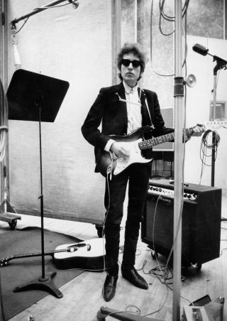 Bob Dylan plays a Fender Stratocaster electric guitar through an Ampeg amplifier while recording his album 'Bringing It All Back Home' on January 13-15, 1965 in Columbia's Studio A in New York City, New York.