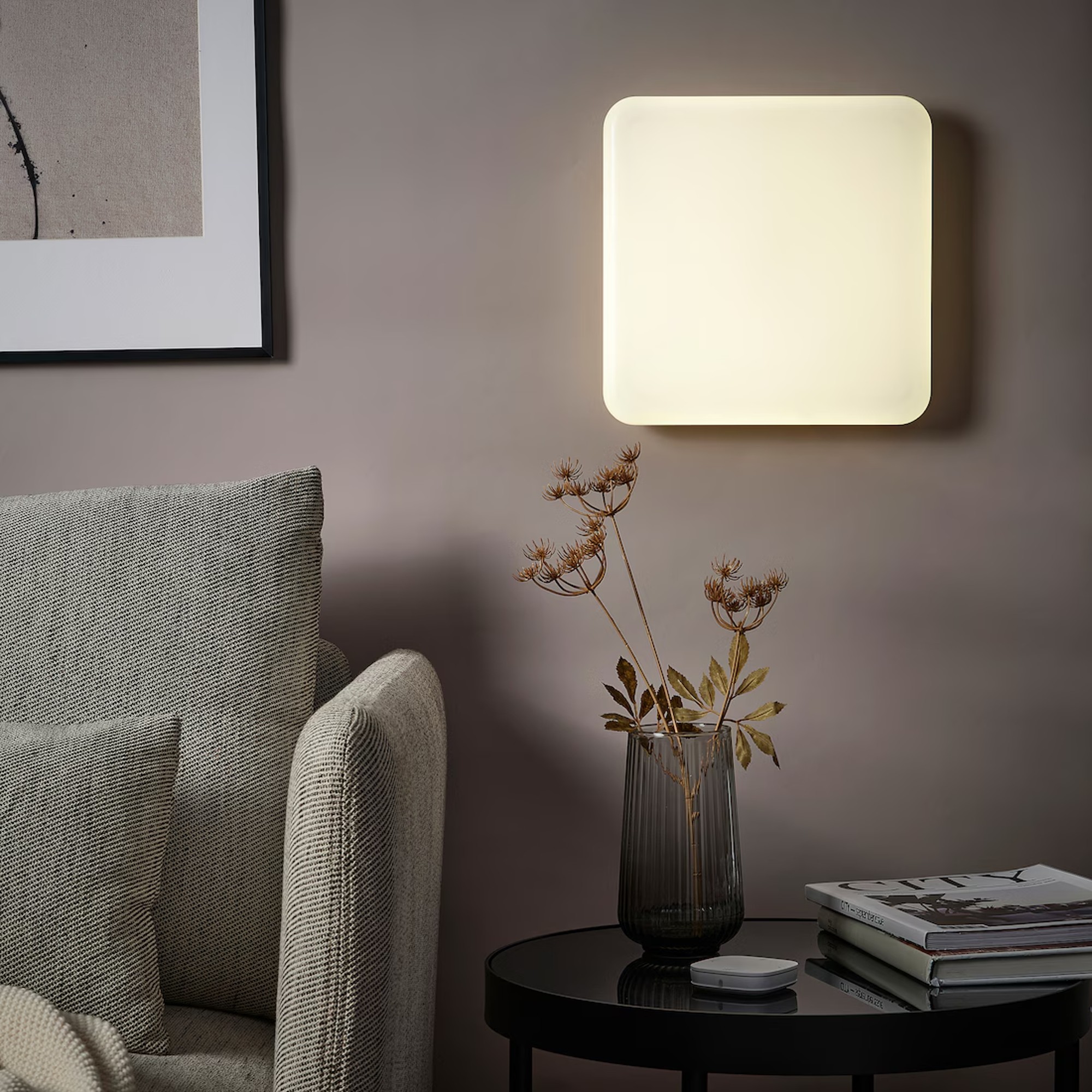 IKEA JETSTRÖM LED wall light panel on a wall in a living room next to a beige armchair