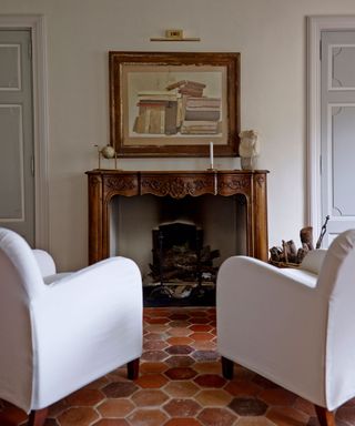 Lorenzo and Mariarosa Pellicioli home. Fireplace, pair of white armchairs
