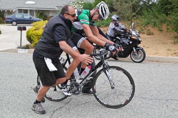 Roman Van Uden (Pure Black) gets a push after a crash in the feed zone.