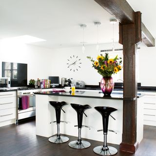 white kitchen with worktop and flower vase